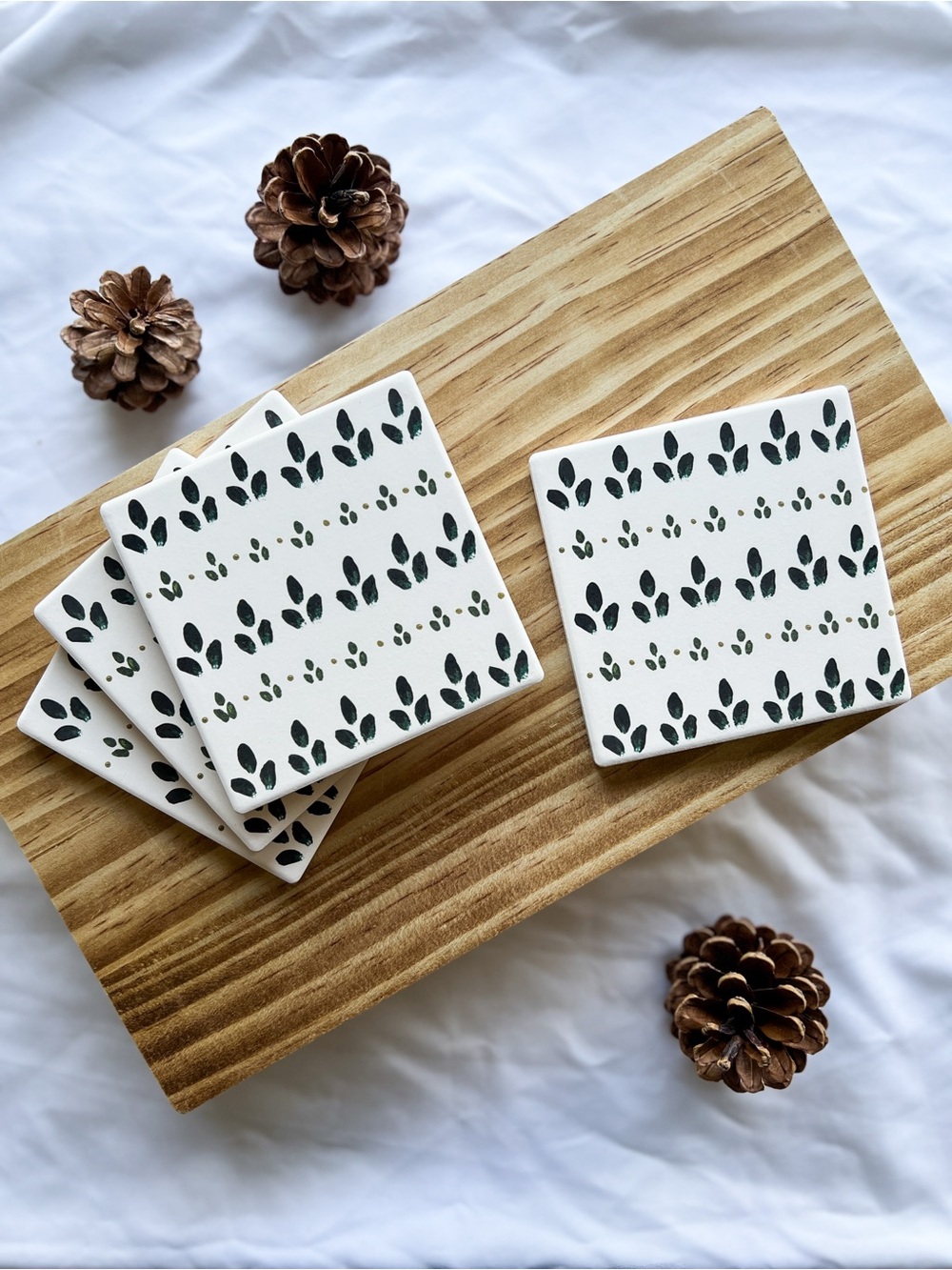 Handcrafted White Ceramic Coaster Set with Dark Green and Gold Leaf Pattern